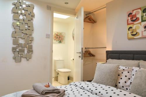 a bedroom with a bed and a toilet in it at Top Floor Apartment in Islington in London