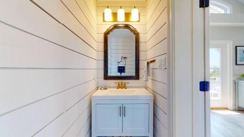 a bathroom with a sink and a mirror at Sundancer in Southport