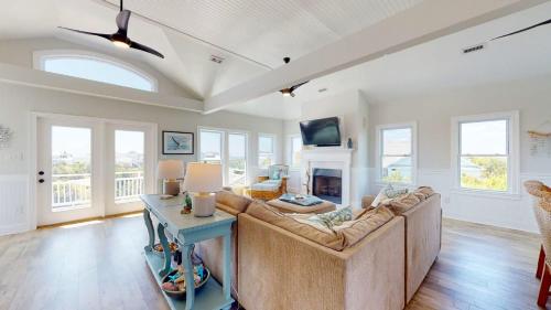 a living room with a couch and a fireplace at Sundancer in Southport