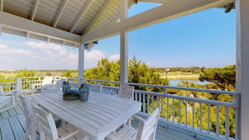 a white table and chairs on a porch with a view at Sundancer in Southport