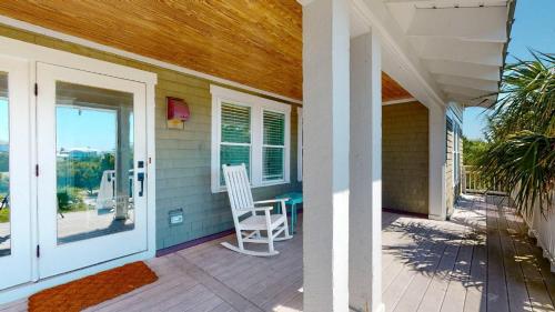 a porch with a white chair on a house at Sundancer in Southport