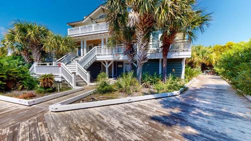 a house with palm trees in front of it at Sundancer in Southport