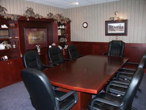 a conference room with a large wooden table and chairs at Coast Abbotsford Hotel & Suites in Abbotsford
