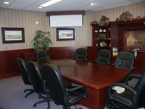a conference room with a wooden table and chairs at Coast Abbotsford Hotel & Suites in Abbotsford