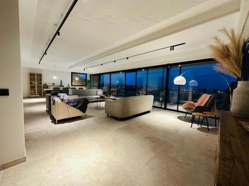 a living room with couches and chairs and windows at Villa Salitre in Costa de Antigua