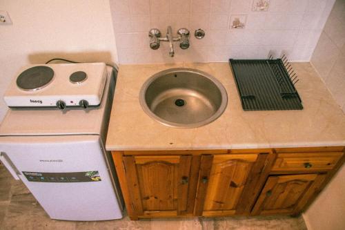 a sink in a bathroom with a weird looking at Thalassopoulia -Zephyrus Room in Ayía Kiriakí