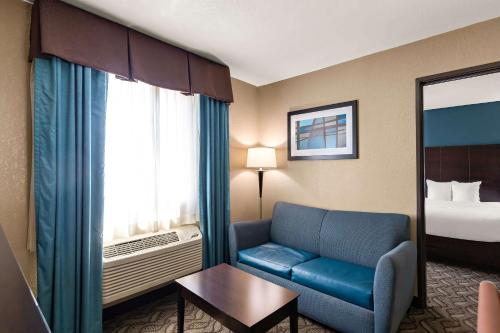 a hotel room with a couch and a bed at Comfort Inn & Suites Springfield I-55 in Springfield