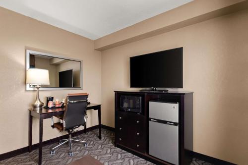 a hotel room with a television and a desk with a chair at Comfort Inn & Suites Springfield I-55 in Springfield