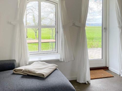 a bedroom with a bed and a window with a view at 4 person holiday home in Aabenraa-By Traum in Aabenraa