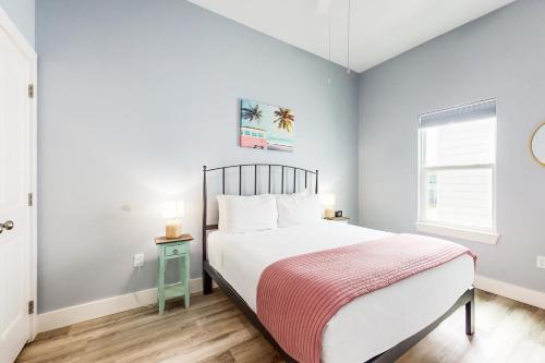 a bedroom with a large bed and a window at Hook Line and Sleeper in Rockport