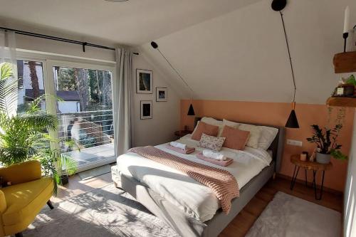 a bedroom with a bed and a large window at Peace of mind cottage in Tata