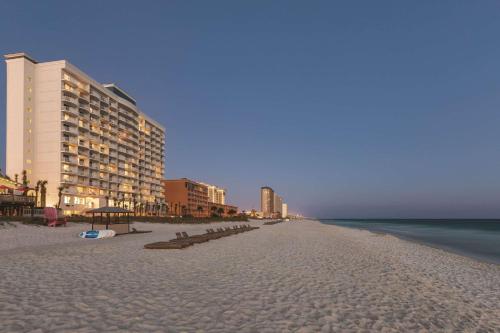 a beach with some buildings and the ocean and the ocean gmaxwell at Radisson Panama City Beach - Oceanfront in Panama City Beach