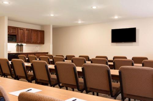 a conference room with tables and chairs and a flat screen tv at Country Inn & Suites by Radisson, Lehighton-Jim Thorpe, PA in Lehighton