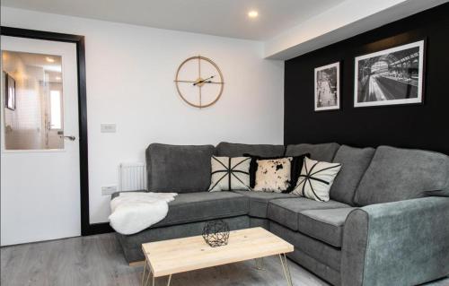 a living room with a gray couch and a table at Room in a shared house Dean Street Coventry CV2 4FB in Coventry