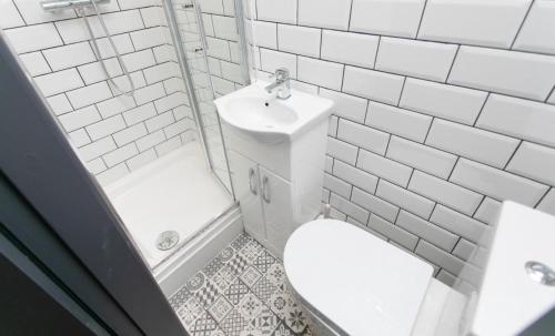 a white bathroom with a toilet and a sink at Room in a shared house Dean Street Coventry CV2 4FB in Coventry