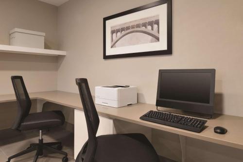 an office with a desk with a computer and a chair at Country Inn & Suites by Radisson, Ft Atkinson, WI in Fort Atkinson