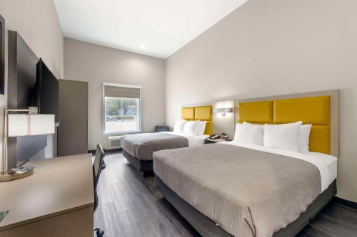 a hotel room with two beds and a television at Quality Inn & Suites Joelton - Nashville in Joelton