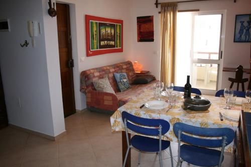 a living room with a table and a couch at Home sweet home in Santa Maria