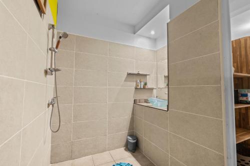 a bathroom with a shower and a toilet in it at Vert Ocean in Le Marin
