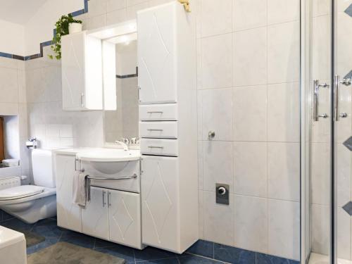 a bathroom with a toilet and a sink and a shower at Auszeit am Bauernhof in Schwoich