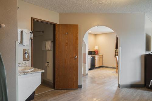 a bathroom with an archway and a sink at Super 8 by Wyndham Grants in Grants