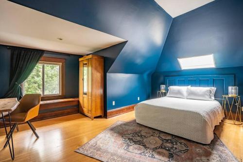 a bedroom with blue walls and a bed and a table at Charming Room in Capitol Hill - Foxglove Inn Rm 6 in Seattle