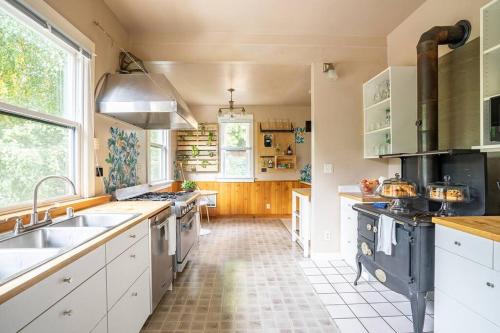a kitchen with a sink and a stove top oven at Charming Room in Capitol Hill - Foxglove Inn Rm 6 in Seattle
