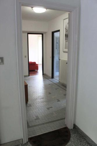 an empty hallway with a hallway leading to a living room at La Piudana Como Lake in Ponna Superiore