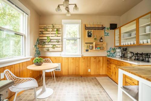 a kitchen with wooden cabinets and a table and chairs at Charming Room in Capitol Hill - Foxglove Inn Rm 4 in Seattle