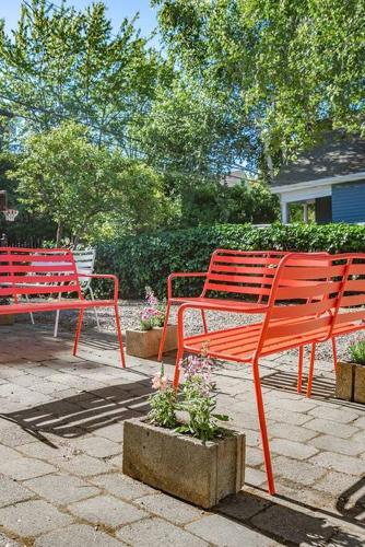 three red benches sitting on a stone patio at Charming Room in Capitol Hill - Foxglove Inn Rm 4 in Seattle