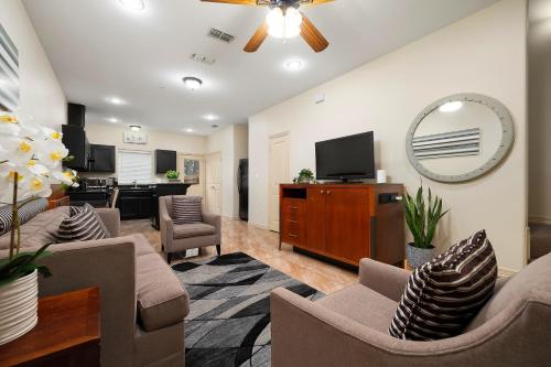a living room with furniture and a flat screen tv at Haven Hideaway-Apartment 4 in Pharr