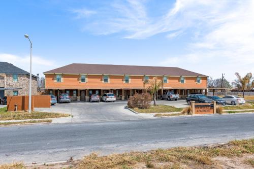 a large building with cars parked in a parking lot at Haven Hideaway-Apartment 4 in Pharr