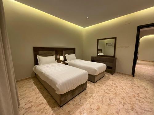 A bed or beds in a room at ميلاس للوحدات المفروشة