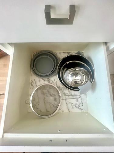 a kitchen sink with two pans in a drawer at ※ Cul-de-Sac Haven, Stylish & Tranquil ~ King Beds in Forney