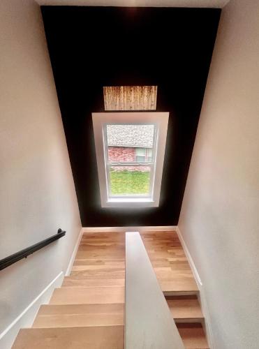 a stairway with a window in a room at ※ Cul-de-Sac Haven, Stylish & Tranquil ~ King Beds in Forney