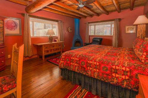 a bedroom with a bed and a wooden floor at Casa Benavides Inn in Taos