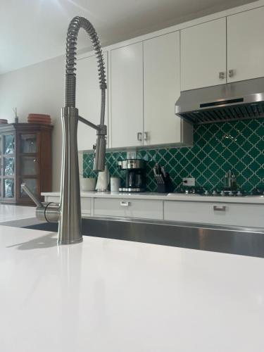 a kitchen with a faucet and a sink in it at ※ Cul-de-Sac Haven, Stylish & Tranquil ~ King Beds in Forney
