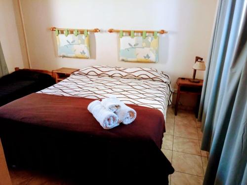 een witte hond op een bed in een slaapkamer bij Life Departamentos in Guaymallen