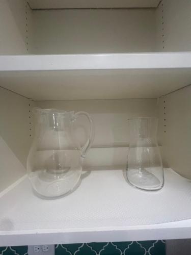 two glass vases sitting on top of a shelf at ※ Cul-de-Sac Haven, Stylish & Tranquil ~ King Beds in Forney