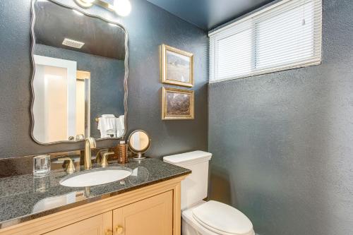 a bathroom with a toilet and a sink and a mirror at Pet-Friendly Denver Home 2 Blocks to City Park! in Denver