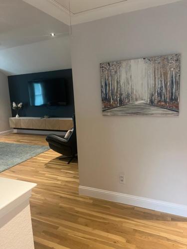 a living room with a painting on the wall at ※ Cul-de-Sac Haven, Stylish & Tranquil ~ King Beds in Forney