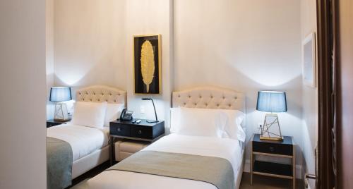 Postel nebo postele na pokoji v ubytování Itza Hotel Boutique Internacional