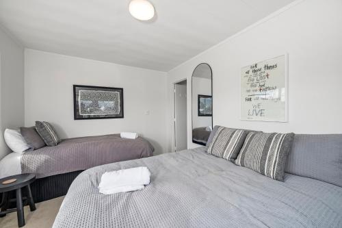 a bedroom with a bed and a couch at Fletcher House. No 1 in Taupo