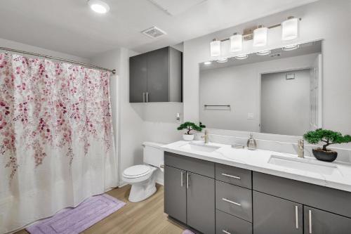 a bathroom with a sink and a toilet and a shower at Spacious two bedroom one bath In Little Italy in San Diego