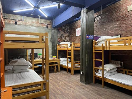 a room with several bunk beds in it at 大连天天青旅民宿 in Dalian