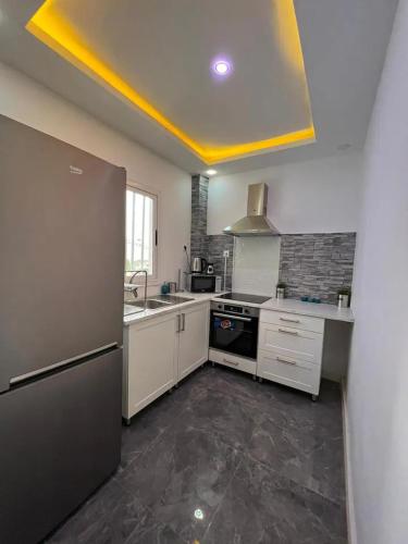 a kitchen with a sink and a refrigerator at American House in Accra