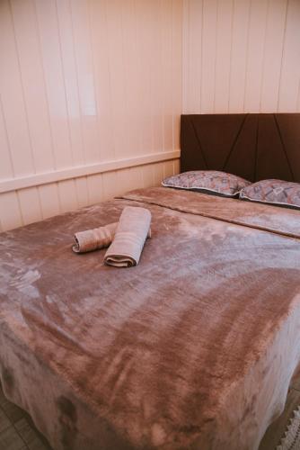 two beds with a blanket and a towel on them at Morada encanto da cachoeira in Aguas Mornas