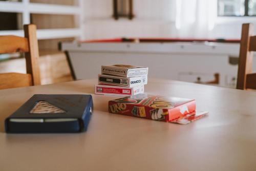 a stack of books sitting on top of a table at Morada encanto da cachoeira in Aguas Mornas