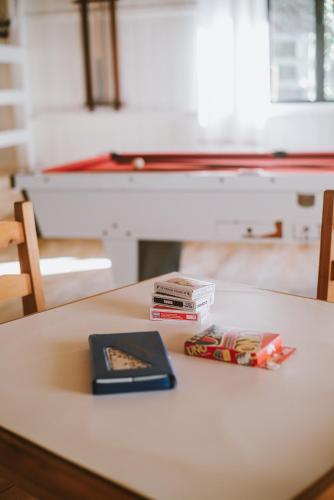 a table with some books on top of it at Morada encanto da cachoeira in Aguas Mornas