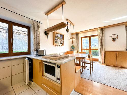 a kitchen with a counter and a dining room at FEWO Elsa in Oberstaufen
